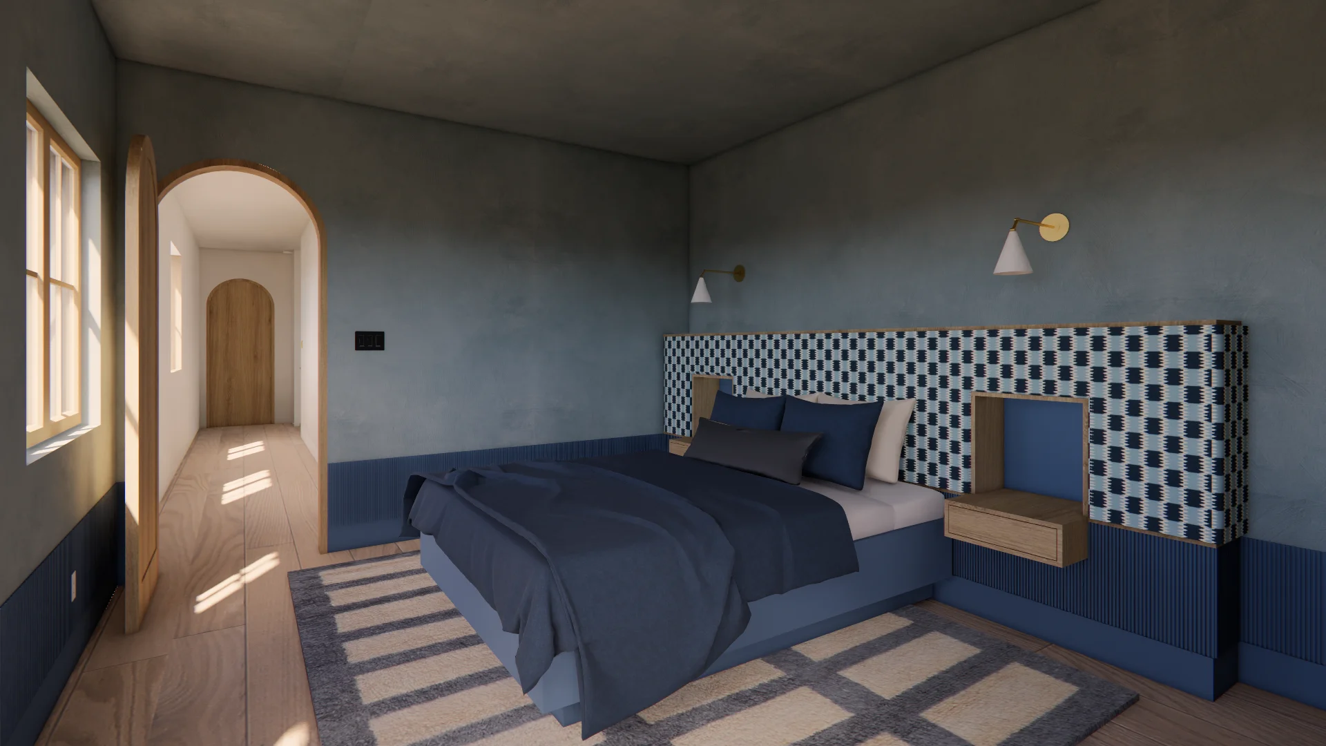 A modern bedroom with a two-tone color scheme features slate-gray walls above a navy blue lower half, accented by a striking black-and-white geometric patterned headboard. Natural light streams through tall windows illuminating the wood flooring, while brass sconce lighting and a neutral color palette of navy bedding and geometric area rugs create a serene, contemporary aesthetic.